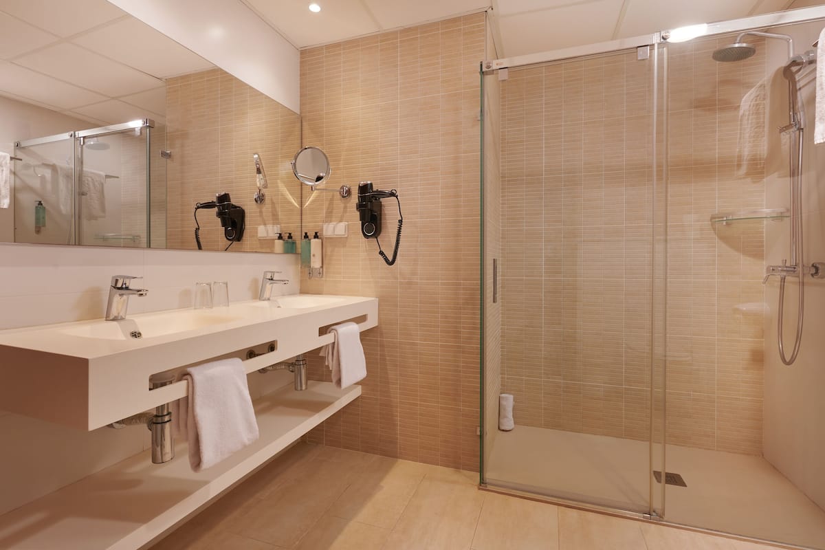 comfort apartment, 1 bedroom, balcony, poolside | bathroom | hair dryer, towels, soap, shampoo