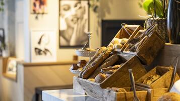 A bakery display with various breads and pastries.