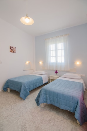 In-room safe, desk, laptop workspace, blackout drapes - Athena Rooms (Ios)