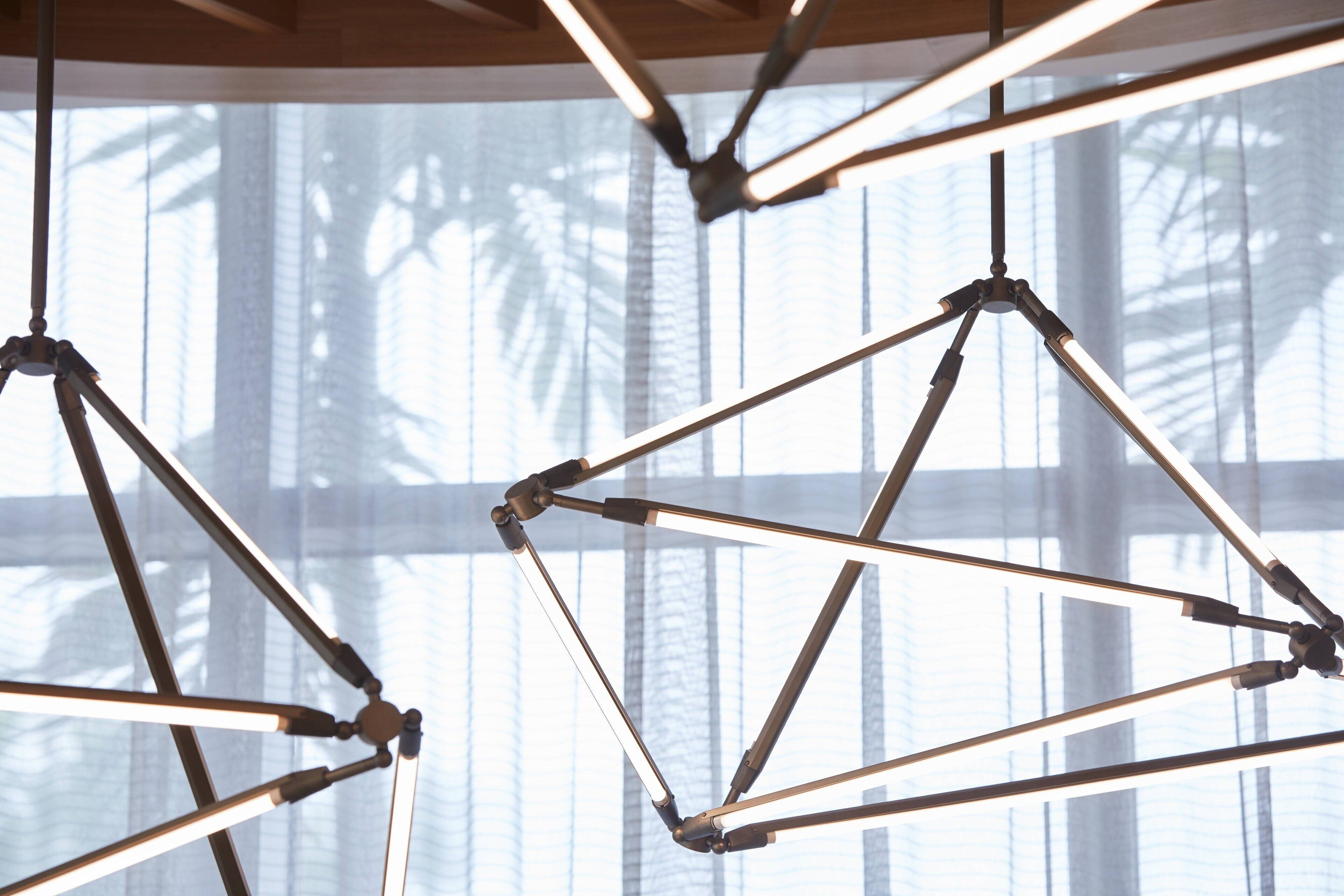A geometric ceiling structure with multiple intersecting beams.