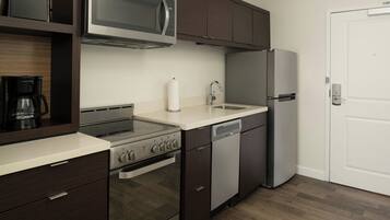 A modern kitchen with a built-in oven, microwave, and dishwasher.