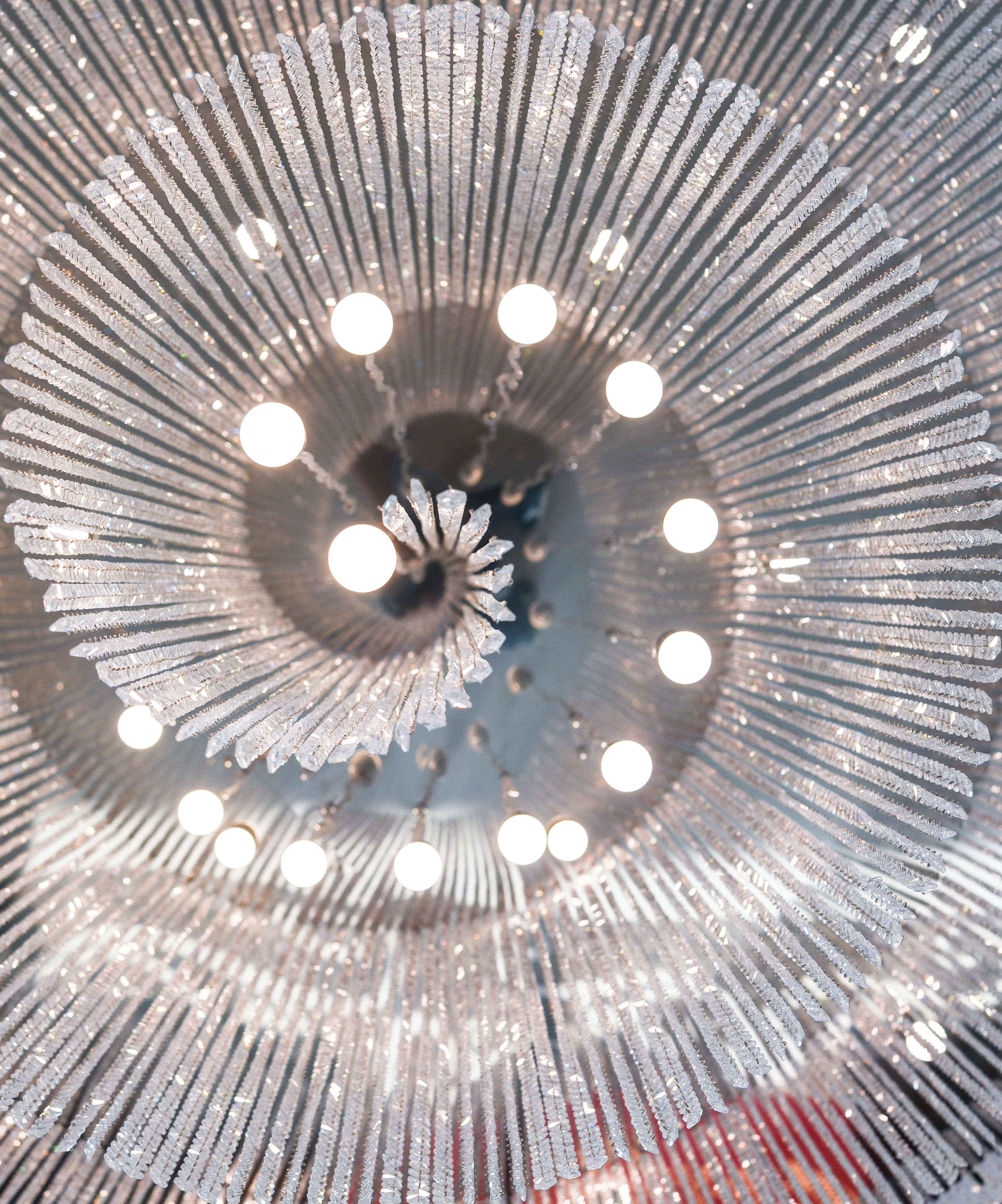 A chandelier with multiple tiers of crystal elements and lights.
