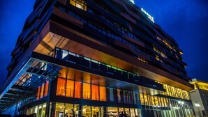 A multi-story hotel with a modern design, featuring large windows and a prominent entrance.