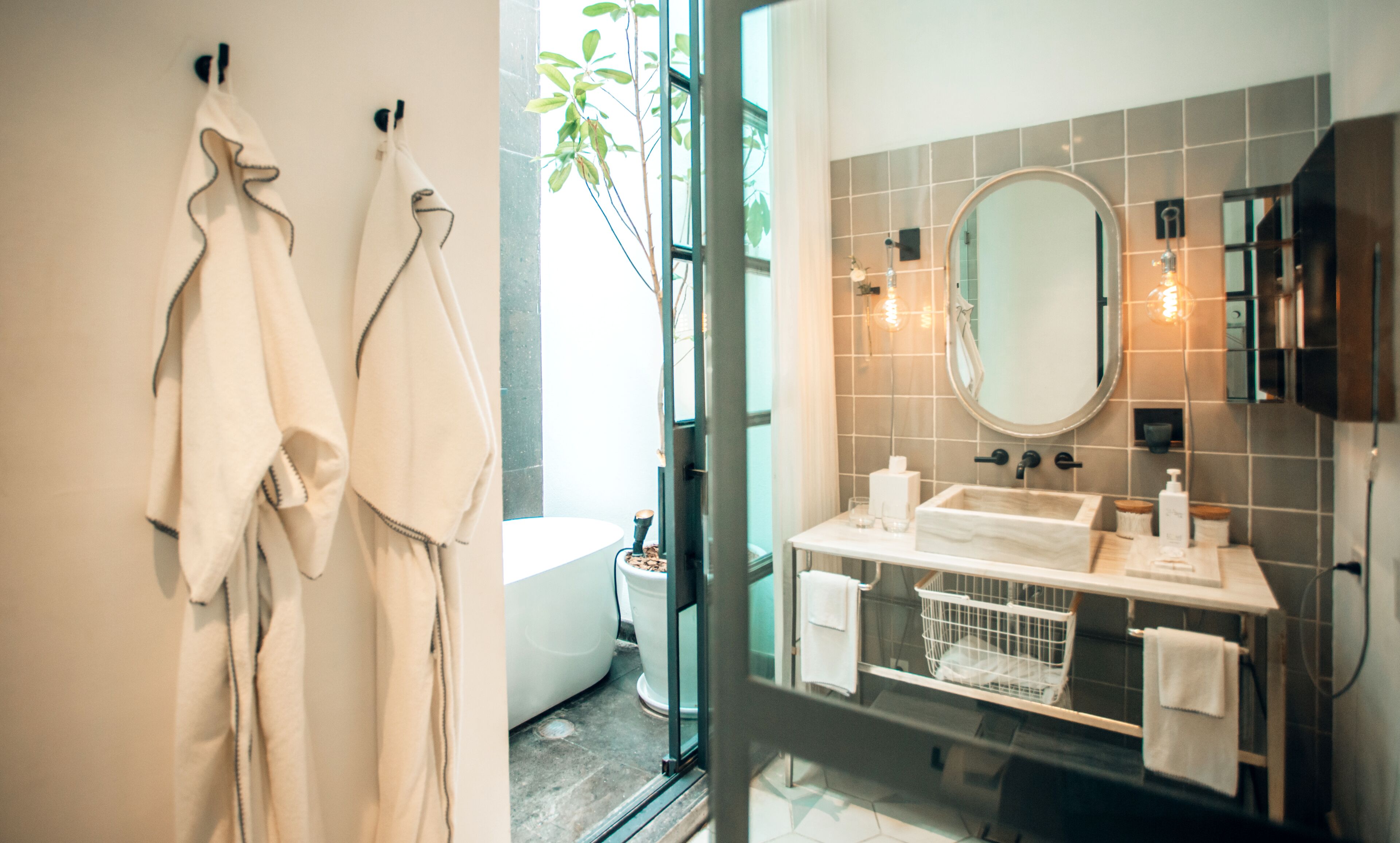 A bathroom with a bathtub, a sink, and a mirror.