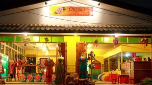 A brightly lit storefront with a sign reading "Chezmo Handmade & Home Stay". - Chezmoi Handicraft & HomeStay (Chiang Rai)