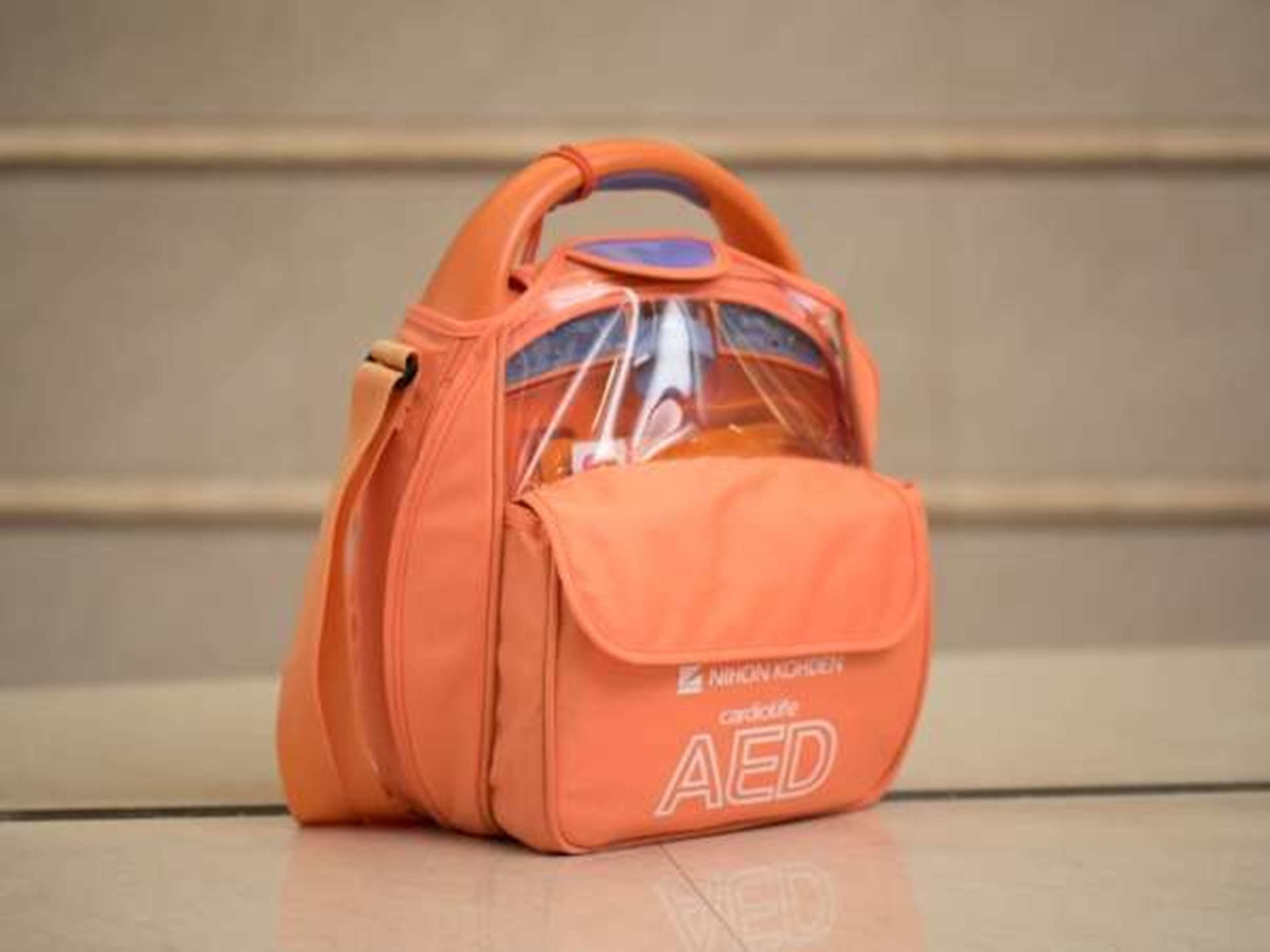An orange bag with a clear window and the text "Nikon AEGIS" and "cardio" on it.