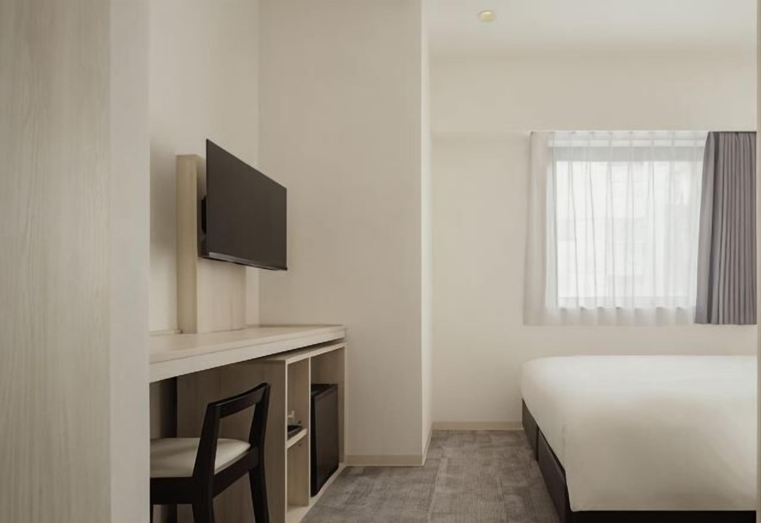 Hypo-allergenic bedding, desk, laptop workspace, blackout drapes