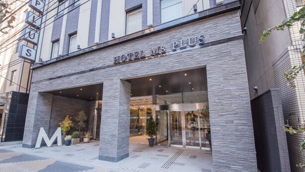 The exterior of Hotel M's Plus with a modern design, featuring a prominent entrance and large letter signage. - Hotel M’s Plus Shijo - Omiya (Kyoto)