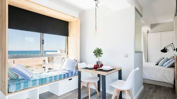 Panoramic Loft, 1 Queen Bed, Sea View, Beachfront | Living room | 22-inch flat-screen TV with satellite channels, TV