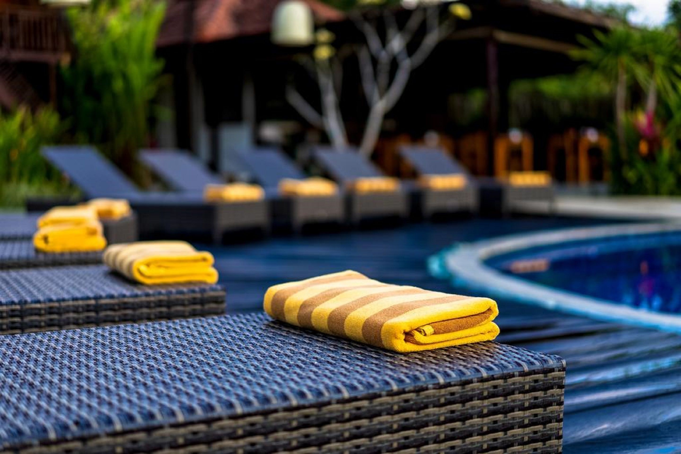 A poolside area with lounge chairs and a small pool.