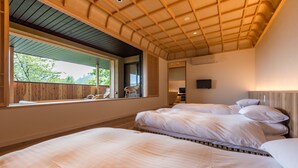 A bedroom with two beds, a large window, and a wooden ceiling. - Hotel Hakuba Hifumi (Hakuba)