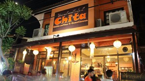 A two-story building with a sign reading "Chita Coffee & Guesthouse."