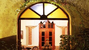 An entrance with a sign reading "RIALD'S," a wooden door, and potted plants. - Riad Ksar El Jadida (El Jadida)