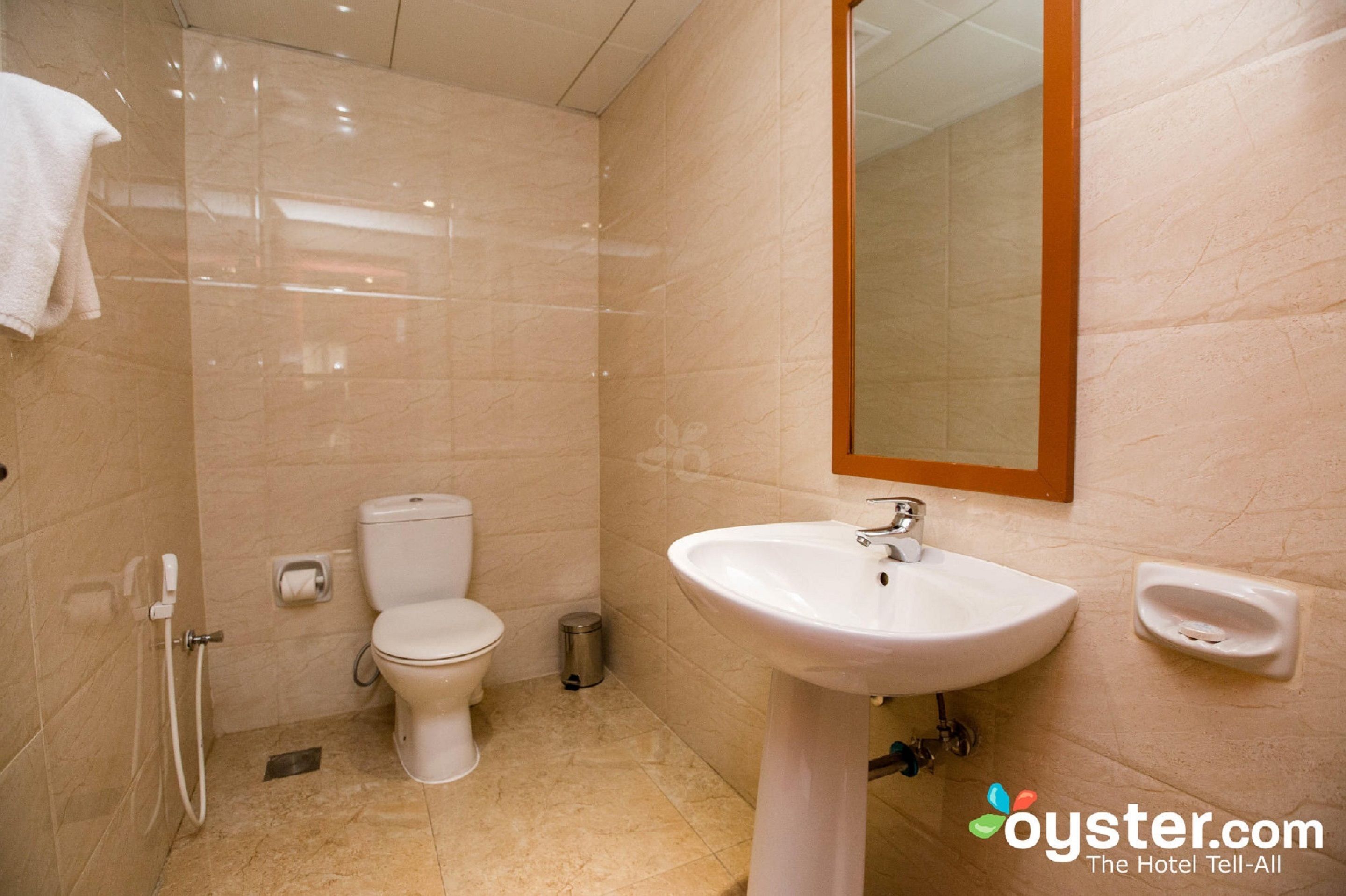 A bathroom with a toilet, sink, and shower.