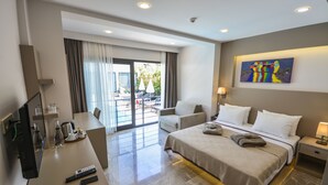 A hotel room with a bed, a desk with a TV, a chair, a nightstand, and a painting on the wall. - Eng Group Hotels (Bodrum)