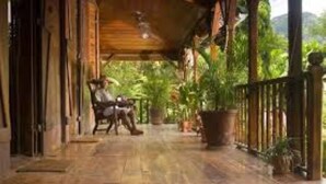 A wooden porch with a bench and potted plants. - Hotel Bel Air (Mahé Island)