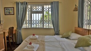 A hotel room with two beds, a desk, and a chair. - Hotel Bel Air (Mahé Island)