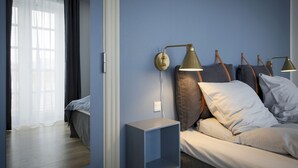 A modern bedroom with a bed, bedside lamps, and a nightstand.