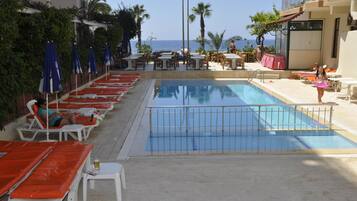 Outdoor pool, open 10 AM to 6 PM, pool umbrellas, pool loungers
