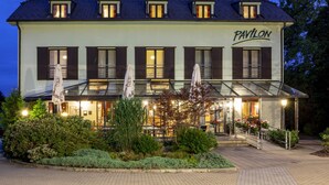 A two-story building with a sign reading "PAVILON" on the facade. - Hotel Pavilon (Ricany)