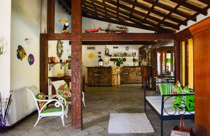 Relax in this stylish space with a high ceiling, stone floor, and comfortable seating area.