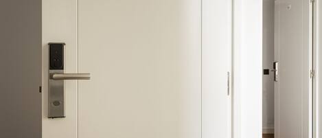 A modern door with a digital lock and a handle.
