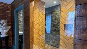 A room with a wooden wall, a herringbone-patterned door, and a stone wall. - OYO The Townhouse (Durham)