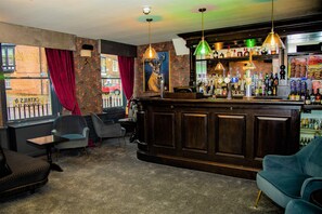 A bar area with a counter, seating, and a view of the street.