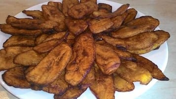 A plate of fried plantains arranged in a circular pattern.