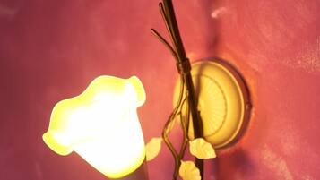 A wall-mounted light fixture with a floral design.