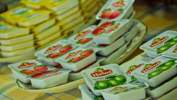 A display of Helios brand yogurt in strawberry and green apple flavors.