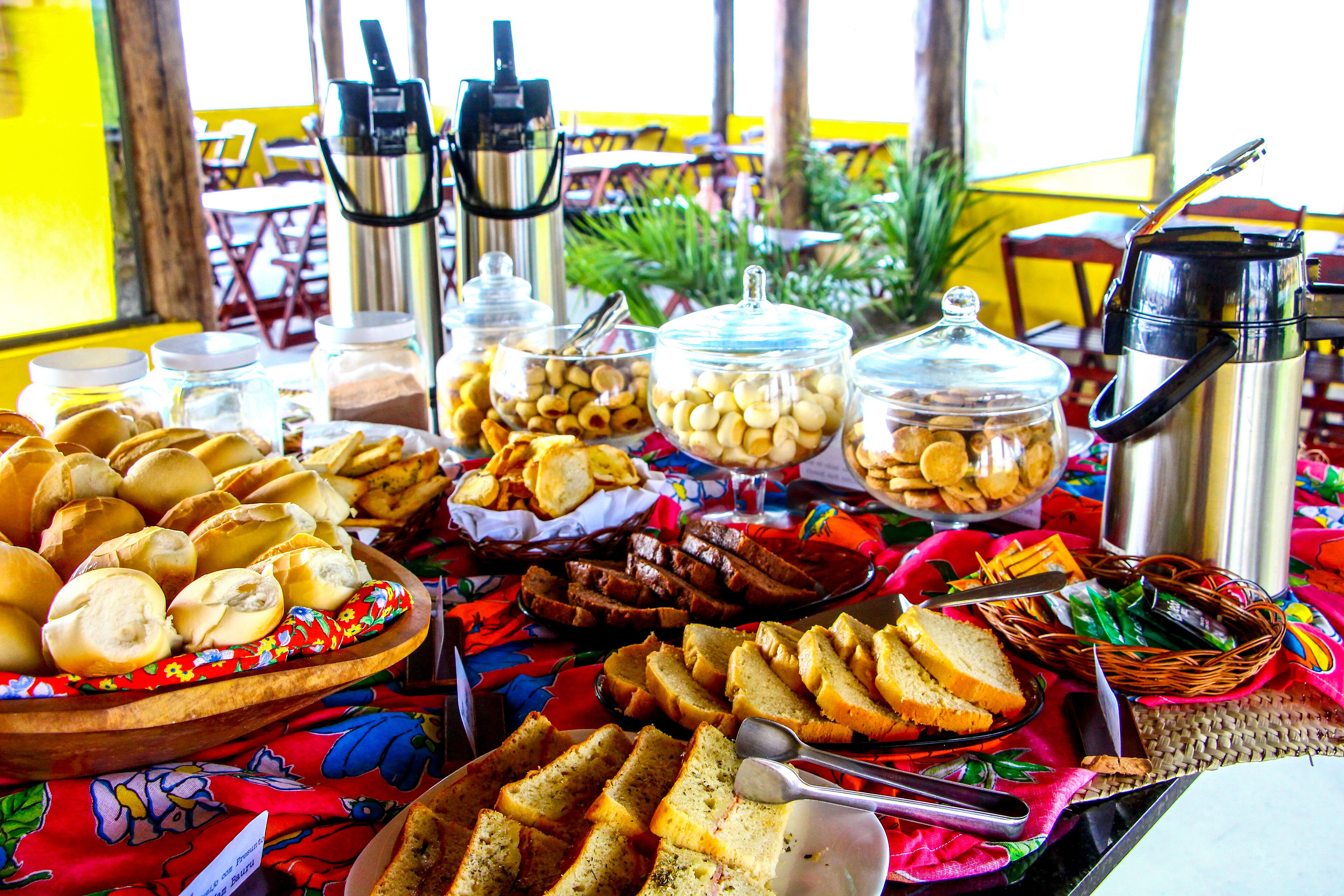A buffet table with various food items and condiments.
