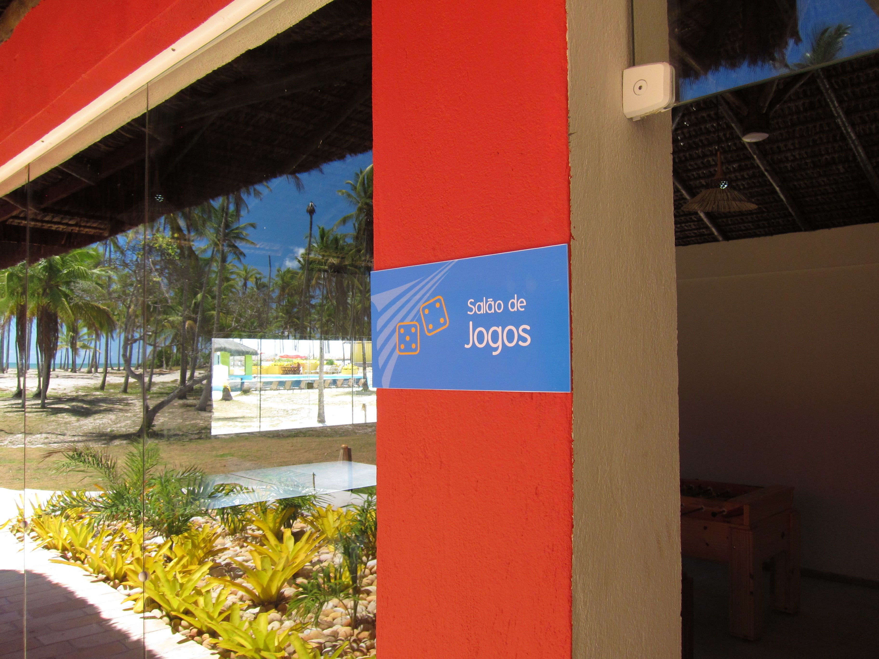 A sign reading "Salão de Jogos" on a building's exterior.