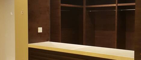 A modern reception desk with a dark wood finish and a light-colored countertop.