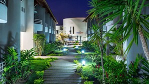 A pathway leading to a hotel entrance with a sign for Portofino Hotel. - Hotel Porto Nápolis (Eunapolis)
