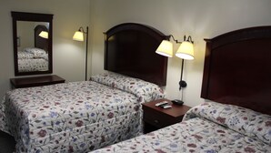A hotel room with two beds, a nightstand, a mirror, and two wall-mounted lamps. - Pleasant Hill Motel (Middletown)