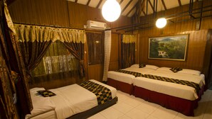 A hotel room with two beds, a painting on the wall, and an air conditioning unit. - Fora Guest House Taman Lingkar (Bandung)