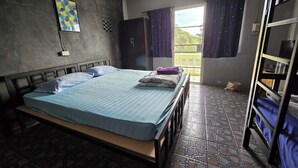 A room with a bed, a wardrobe, a window with curtains, and a balcony. - Malai Place Lampang (Lampang)