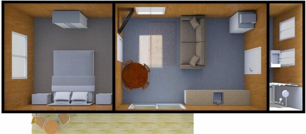 A hotel room with a bed, a desk, a chair, a sofa, a small table, and a window.