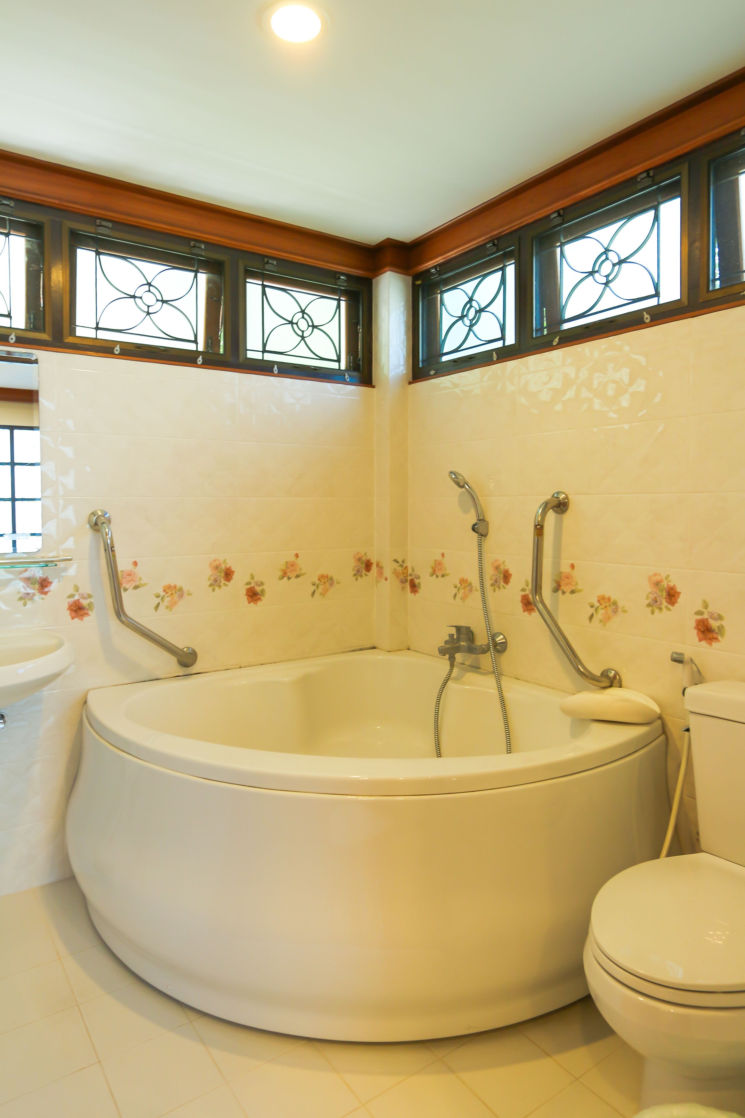 A bathroom with a large bathtub, a toilet, and a sink.