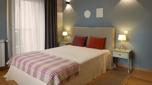 Une chambre à coucher avec un lit, deux tables de chevet avec des lampes, une fenêtre avec des rideaux et un mur orné de deux appliques murales.