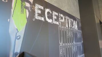 A wall with the word "RECEPTION" and a series of hanging keys.