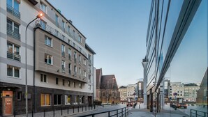 A modern building with a flat facade, multiple windows, and a visible entrance. - Absynt Apart Wierzbowa (Wroclaw)