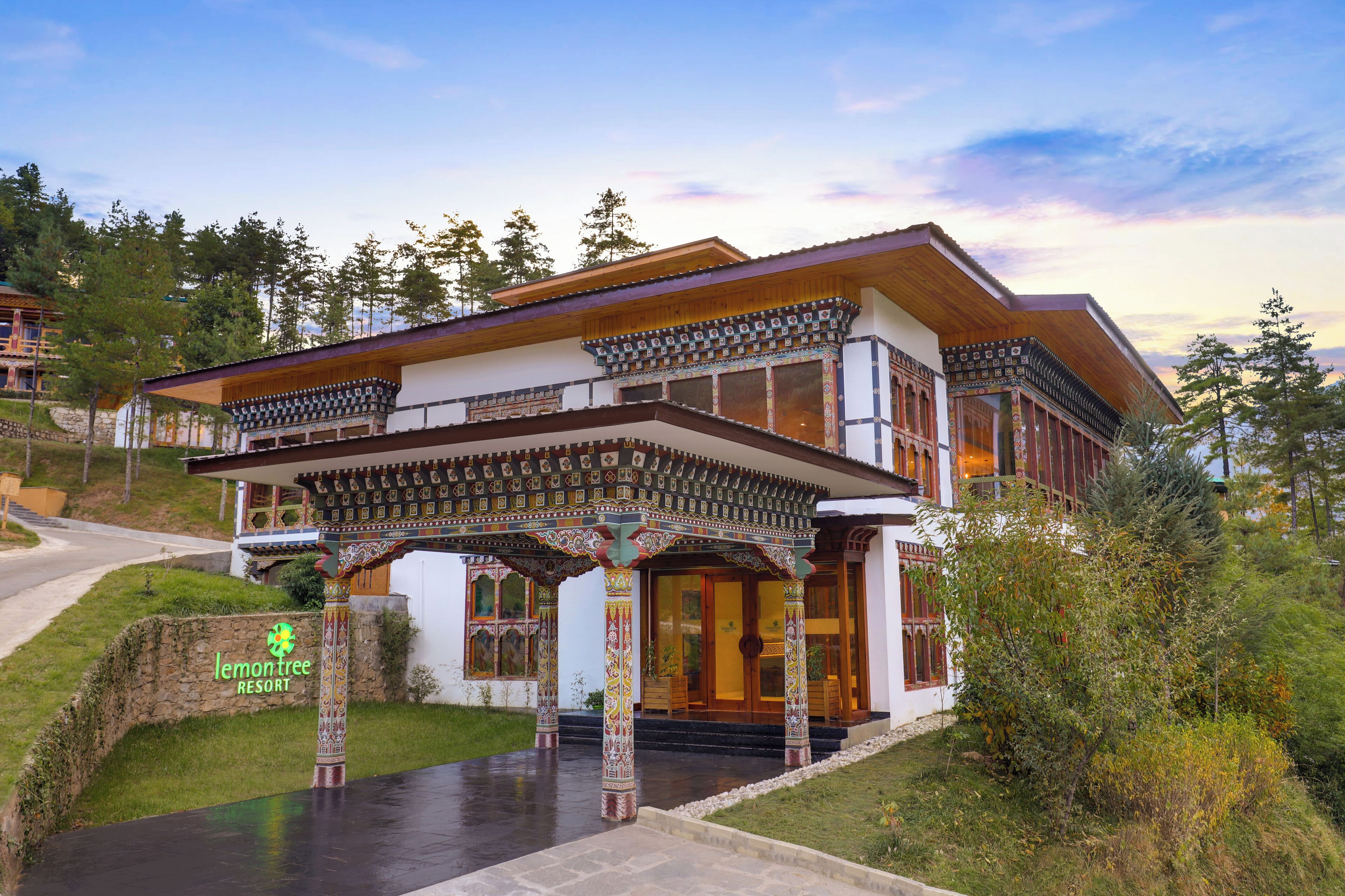 A two-story building with a traditional architectural style, featuring a covered entrance with intricate patterns.