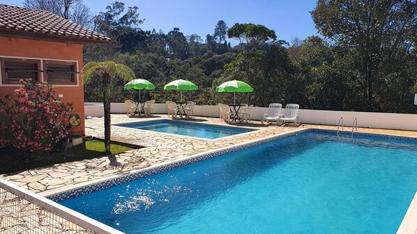 Outdoor pool, open 10:00 AM to 7:00 PM, pool loungers