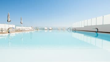 Seasonal outdoor pool, open 9:00 AM to 7:00 PM, pool umbrellas