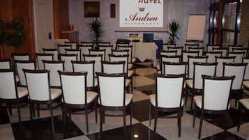 A Brindor Hotel Andrea Restaurante with a checkered floor and rows of wooden chairs.