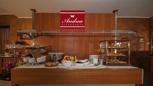 A buffet setup with various food items and a sign reading "Andrea Ristorante". - Brindor Hotel (Poirino)