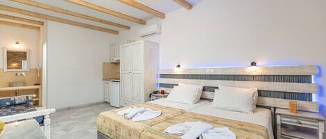A bedroom with a large bed, bedside tables, a desk, and a wardrobe.