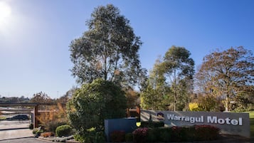 Señal del Motel Warragul, con cielo despejado y vegetación circundante.